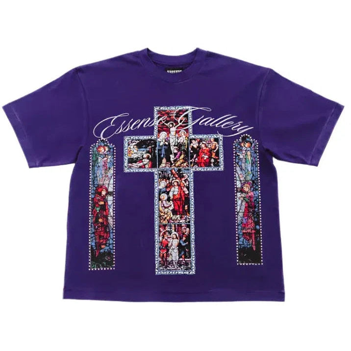 A purple short-sleeve t-shirt featuring a large graphic print on the front. The design includes a central cross made of colorful stained-glass-style panels, two matching vertical panels on either side, and the words 'Essentials Gallery' in white script across the chest.