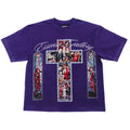 A purple short-sleeve t-shirt featuring a large graphic print on the front. The design includes a central cross made of colorful stained-glass-style panels, two matching vertical panels on either side, and the words 'Essentials Gallery' in white script across the chest.