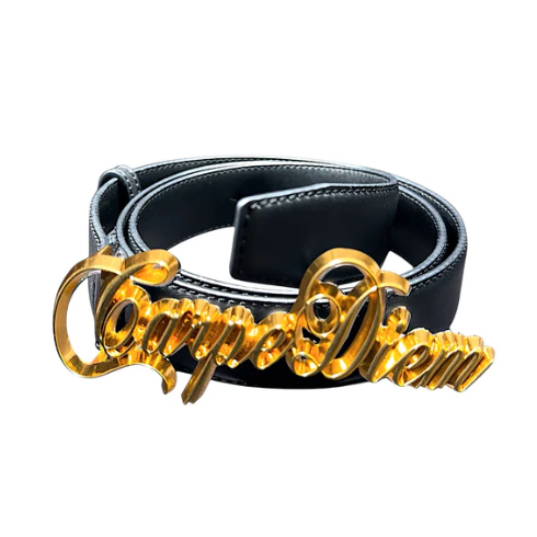 A black leather belt with a highly polished gold-tone script buckle spelling 'Carpe Diem', set against a plain white background.